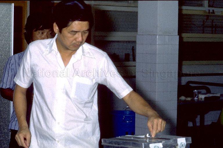 1998 General Election - Gentleman slipping his ballot into ballot box at Hong Wen School polling station