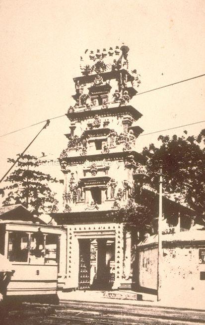 Sri Mariamman Temple at 244 South Bridge Road, Singapore, with an electric tram in front.