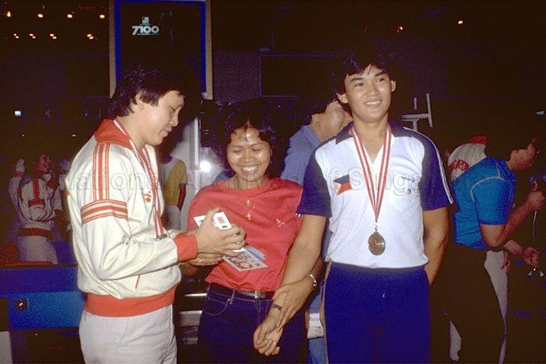 Southeast Asian (SEA) Games - Singapore bowler Ronnie Ng signing an autograph after winning gold medal for men's masters event at Jackie's Bowl Orchard; on the right is silver medalist Raul Reformado from the Philippines