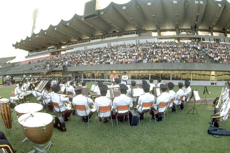Singapore Police Band performing at A Salute to Singapore party at the National Stadium. The party was the finale for the Salute to Singapore book project organised by Times Organisation to celebrate 25 years of self-rule in Singapore. Only 25-year-olds were invited and about 7,000 showed up for the party and mass group photo.