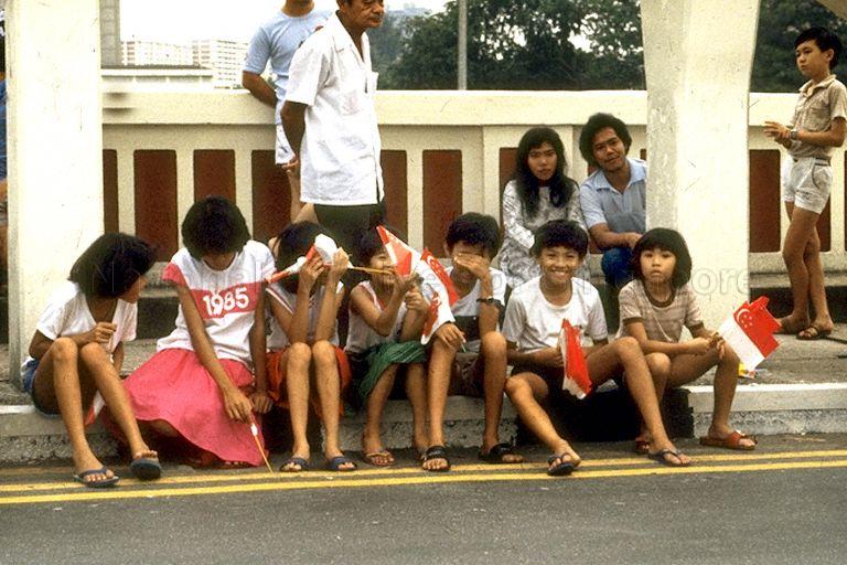 National Day Parade 1985 at National Stadium -- Spectators waiting to view parade along the street