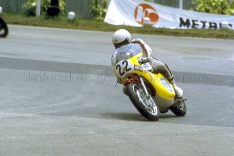 View of Akiyasu Motohashi of Japan, second-place winner of the 50-lap Singapore Grand Prix for motorcycles, negotiating the Sembawang Circus Hairpin at Thomson Road circuit