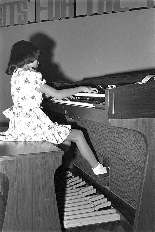 Julia Wee playing the organ at the second Music for the Young concert at the National Library Lecture Hall.