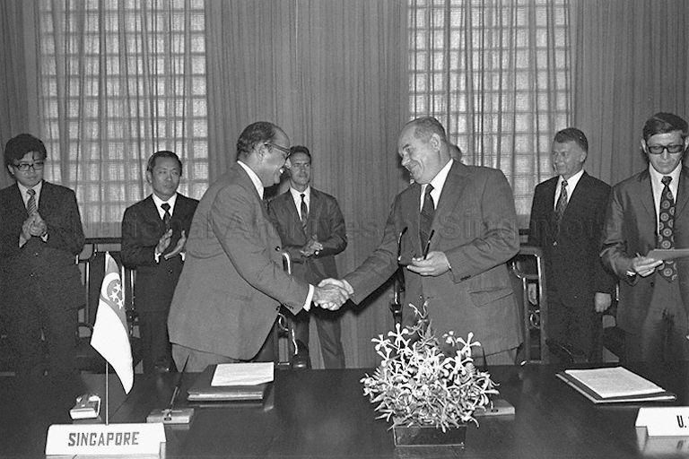 Singapore and Soviet officials shaking hands after the signing of a cultural and scientific agreement at the Prime Minister's Office conference room at City Hall.
