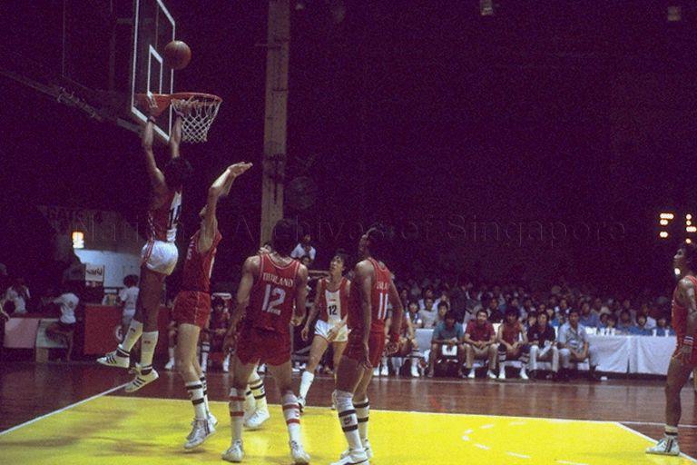 Southeast Asian (SEA) Games basketball game between Singapore (in striped shirts) and Thailand at Gay World Stadium