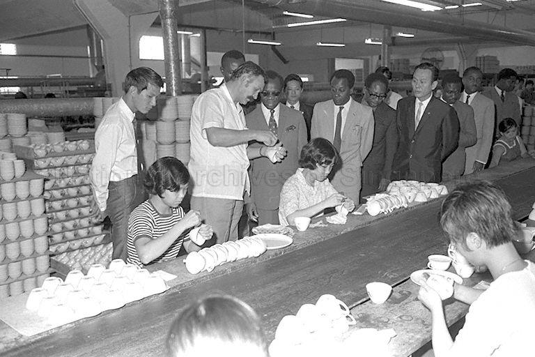Ghanaian Prime Minister Kofi Abrefa Busia (centre, wearing light-coloured suit) touring a factory at Jurong Industrial Estate.