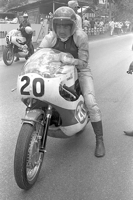 Motorcyclists preparing to ride their motorcycles before the start of the race during the Singapore Grand Prix 1971 at Sembawang Hills Circuit.