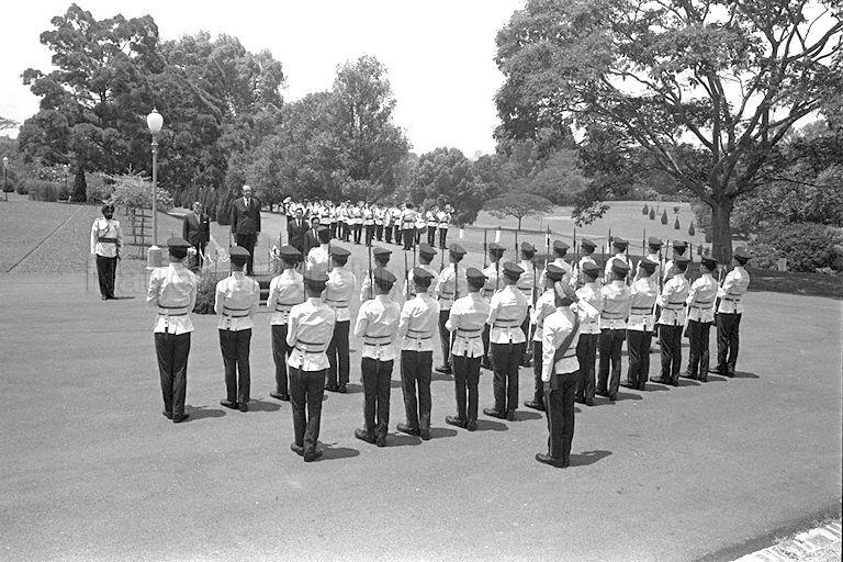 Hungarian Ambassador-designate Dr Peter Kos (standing on stage) reviewing guard of honour ceremony at Istana. Dr Kos was Hungary's first ambassador to Singapore.