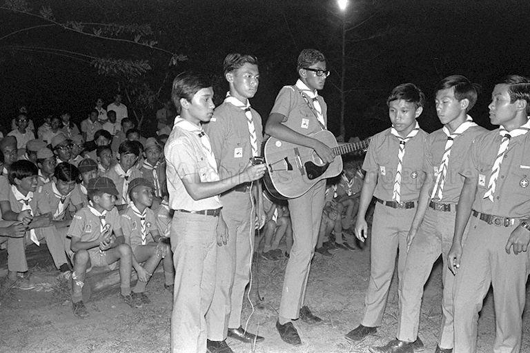 A performance at the scouts' campfire at Sarimbun Scout camp, off Lim Chu Kang Road. This picture is taken during the visit of President Dr Benjamin Henry Sheares.