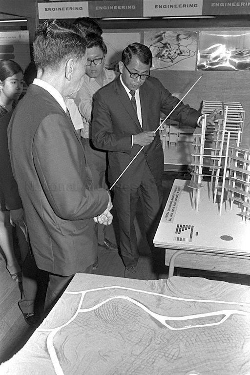 President Dr Benjamin Henry Sheares, who is also Chancellor of University of Singapore, is briefed by Director of Development Unit of University of Singapore Ho Pak Toe on the phases of work to be carried out for Kent Ridge campus during a visit to the University of Singapore campus at Bukit Timah.