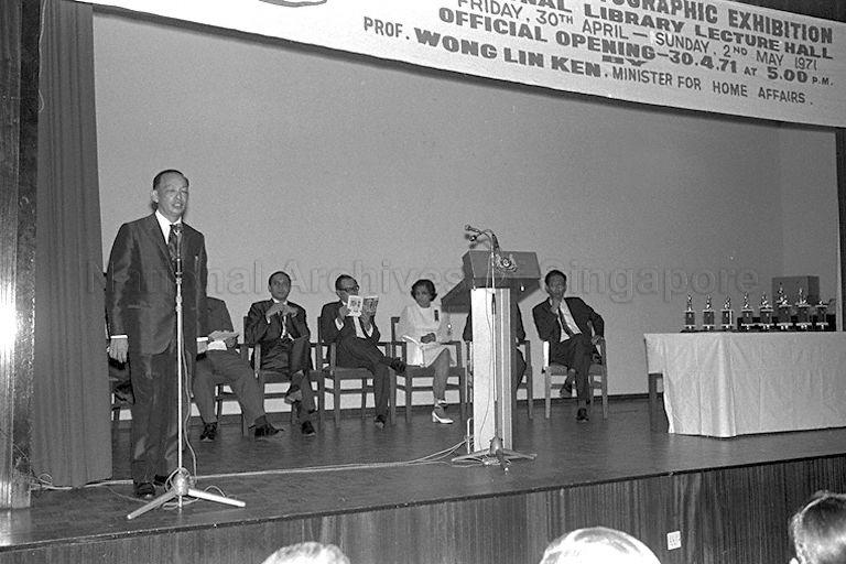 A speech is given during the opening of the three-day Adult Education Board's Photographic Exhibition at the National Library. Also present are Minister for Home Affairs Dr Wong Lin Ken (seated fourth from right) and Minister of State for Education Dr Lee Chiaw Meng (seated fifth from right).