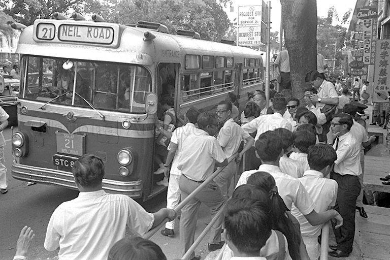 Officials observing school children queuing up at bus-stop after Parliamentary Secretary to Ministry of Education Dr Lee Chiaw Meng launched "Queue-up at bus-stops" campaign at Tanjong Katong Girls' School.