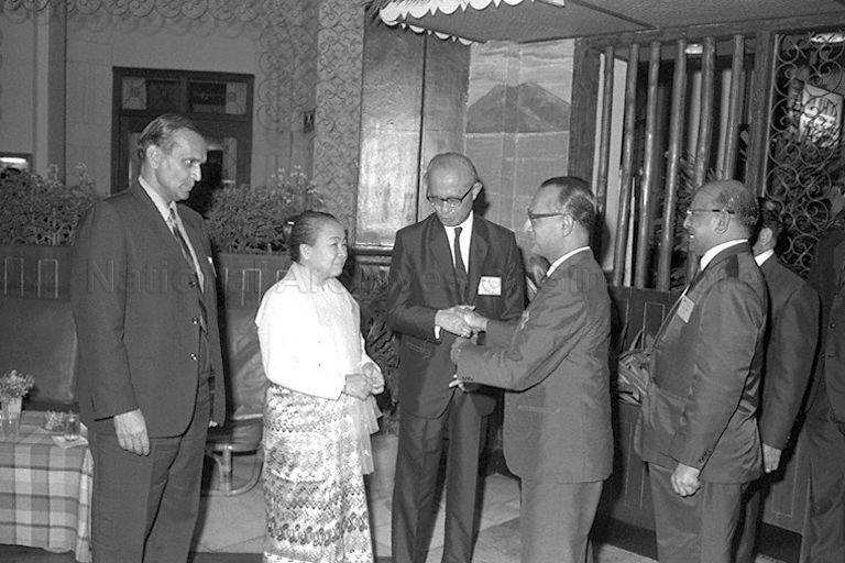 Chief of United Nations Cabinet C V Narasimhan (left), Executive Secretary of Economic Commission for Asia and the Far East (ECAFE) U Nyun and his wife welcoming guests to the Raffles Hotel reception given by U Nyun for delegates of the 25th session of ECAFE