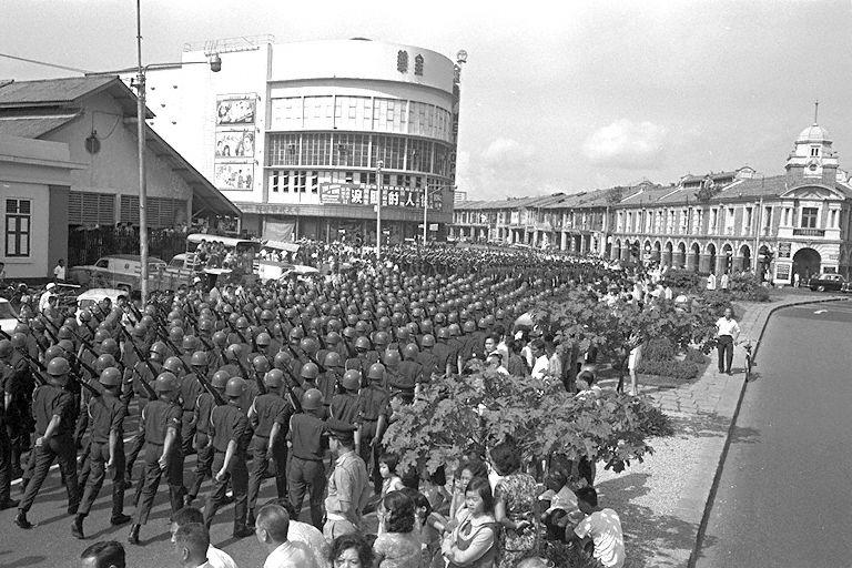 National Day Parade 1969 Third Rehearsal at the Padang - Contingents marching along South Bridge Road, turning to Maxwell Road. Buildings in the background include (from right) Jinricksha Station, Metropole Theatre and Maxwell Market.