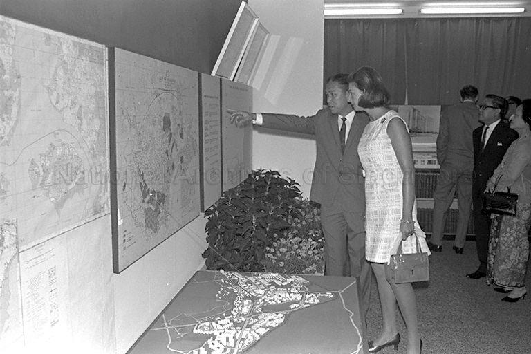 Princess Alexandra of United Kingdom, who is in Singapore for a six-day visit as her cousin Queen Elizabeth's special representative to Singapore's 150th anniversary celebrations, being briefed by Chairman of Housing and Development Board (HDB) Pang Tee Pow while viewing exhibits during visit to HDB headquarters at Princess House