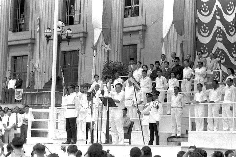 Prime Minister Lee Kuan Yew delivering address during launch of National Loyalty Week after installation of the first Malayan-born Yang Di-Pertuan Negara Yusof bin Ishak at City Hall steps