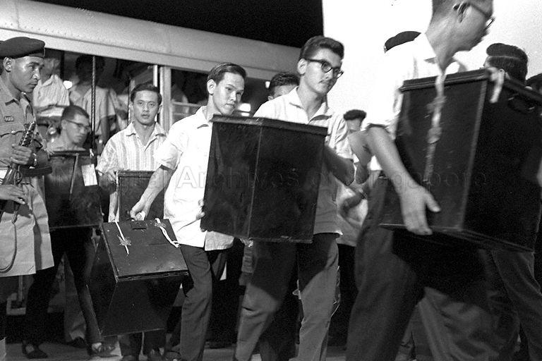 Ballot boxes arriving at Singapore Badminton Stadium counting centre during the Singapore National Referendum on Singapore-Malaya merger