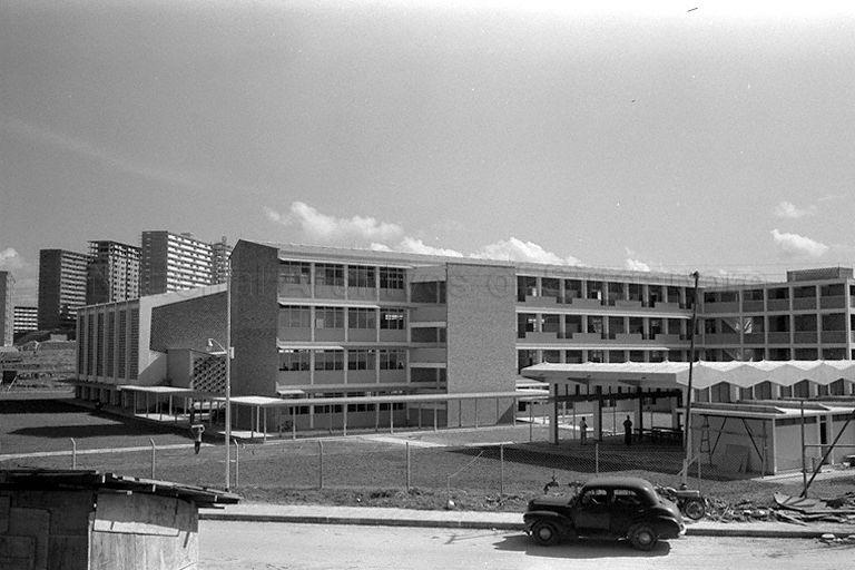 Tanglin Integrated Secondary Technical School at Tanglin Halt. The three background blocks are the '16 storeys' on top of the hill slope which were part of the school field of New Town Secondary. Both schools were already relocated, but the big field with the hill slope still exists.