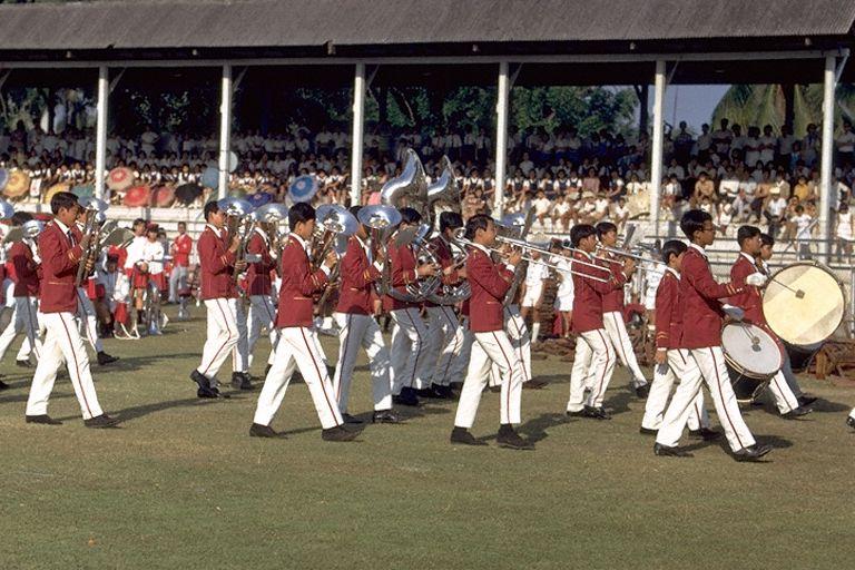 Mass band display by twelve primary and secondary school bands at Opening of Singapore Youth Festival at Jalan Besar Stadium. The Festival, an annual event organised by Ministry of Education, started in 1967 to promote students' interest in the arts and extra-curricular activities.