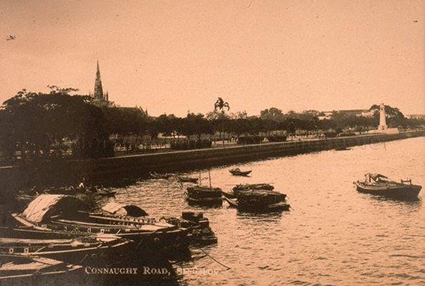 View of Connaught Drive from the sea, Singapore. The spire of St Andrew's Cathedral can be seen above the tree and the Cenotaph on the right.