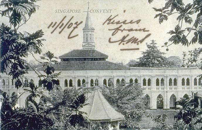 View of gothic linkway and verandah, with pointed arches below and arcade of coupled pointed arches above, at Convent of the Holy Infant Jesus (CHIJ). The convent, located at corner of Bras Basah Road and Victoria Street and thus affectionately called "Town Convent", was founded in 1852 by Father Jean Marie Beurel who bought the former private residence of H C Caldwell, built by George Coleman in the 1840s. In the background is the steeple of Cathedral of Good Shepherd, located opposite the convent, along Victoria Street.