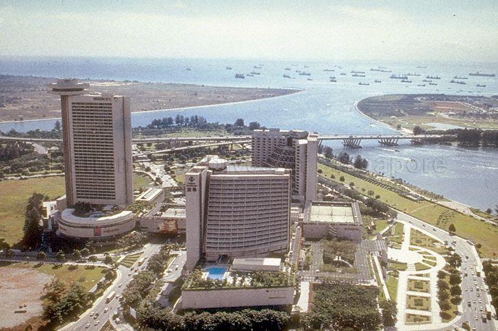 Aerial view of Marina Square shopping mall and hotels in the Marina Bay area. Hotels from left to right: Pan Pacific, Marina Mandarin, The Oriental, and Benjamin Sheares Bridge over the waters in the right background