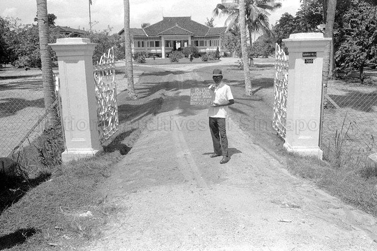 Sewerage works by Public Works Department (PWD). The PWD worker is holding a chalk board in front of house No. 320, Upper East Coast Road. This house is also known as the Sarawak Villa.