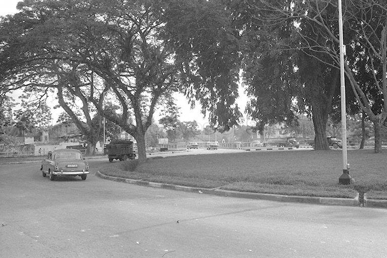 A Mercedes Benz model S180 taxi travelling along Newton Circus