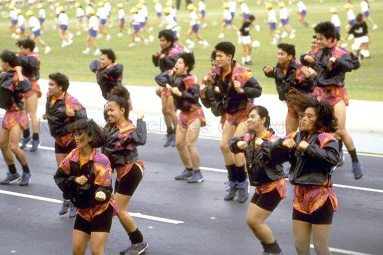 National Day Parade 1993 at the Padang -- Participants from People's Association performing aerobics in mass display item Vitality in Motion, depicting the theme "Good Health" with different kinds of sports