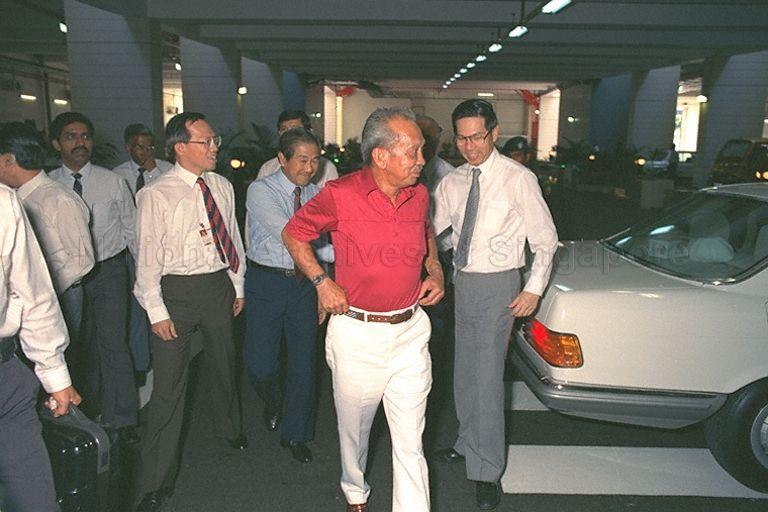 Malaysia's Yang di-Pertuan Agong of Malaysia, Sultan Iskandar of Johor (red shirt), arriving to tour Changi airport's cargo complex. Flanking the King are Chairman of Civil Aviation Authority of Singapore (CAAS) Sim Kee Boon (left) and Second Deputy Prime Minister Ong Teng Cheong (right).
