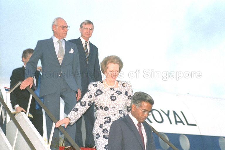 British Prime Minister Mrs Margaret Thatcher and her husband Denis Thatcher (second from left) descending aircraft ramp at Changi Airport led by Director of Protocol and Consular Division of Ministry of Foreign Affairs V K Rajan. Behind Mr Thatcher is British High Commissioner to Singapore Michael Edmund Pike. Mrs Thatcher is in Singapore on a two-day official visit at the invitation of Prime Minister Lee Kuan Yew.