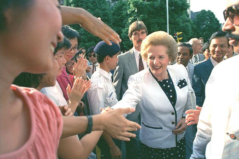 Outside Comcentre, Telecoms' headquarters in Exeter Road, British Prime Minister Mrs Margaret Thatcher (centre) shaking hands with those within her reach.