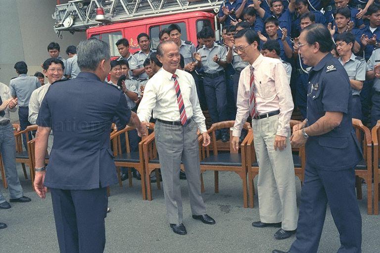 (From left) Fire Service Director Arthur Lim Beng Lock (back to camera), Senior Minister of State for National Development and Home Affairs Dr Lee Boon Yang, and Deputy Director (Operations and Training) Tan Jin Thong sending off President Wee Kim Wee at Ang Mo Kio Fire Station in Ang Mo Kio Avenue 9. The visit is the last of Mr Wee's familiarisation tour of fire stations.