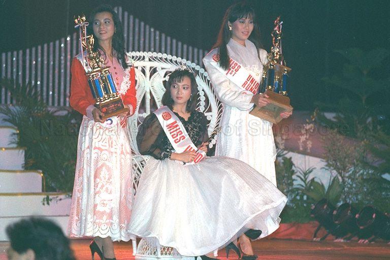 Miss Cerlyn Neo, 23, a clerk, winning the title of Miss Union 1989 organised by National Trades Union Congress (NTUC) at Neptune Theatre Restaurant. Miss Neo also wins two other titles - Miss Body Beautiful and Miss Elegance. She is flanked by Miss Jessica Foo (right), 22, and Miss Jacqueline Foo (left), 23, also clerks, who are named first and second runners-up respectively. They also win the titles of Miss Crowning Glory and Miss Photogenic respectively.