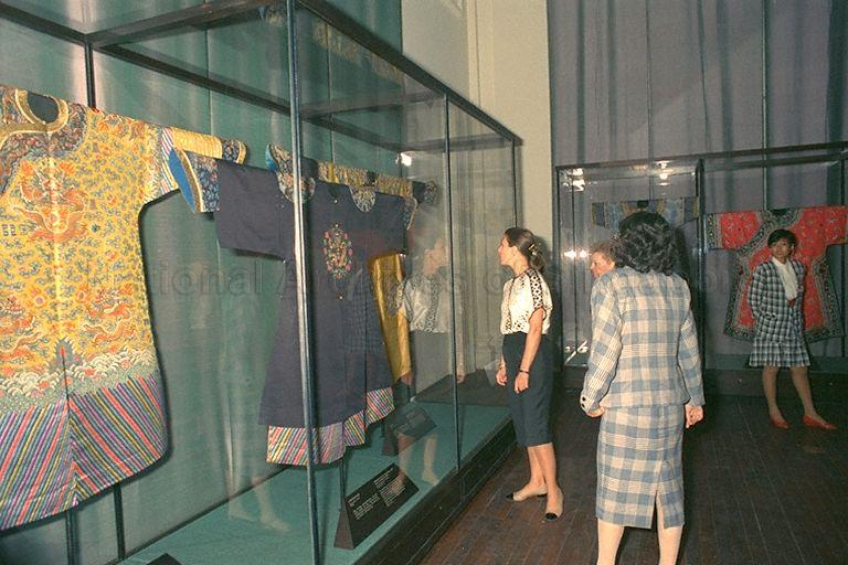 (From left) Mrs Marilyn Quayle (first), wife of Vice-President of the United States  of America (US) Dan Quayle, and Mrs Daryl Arnold (second, face only), wife of US Ambassador to Singapore, viewing Imperial garments of the Qing Dynasty. With them is Mrs Grace Wong (third), General Manager of Historical and Cultural Exhibitions which runs the museum at Empress Place. Mrs Quayle is especially interested in the weaving techniques of the garments.