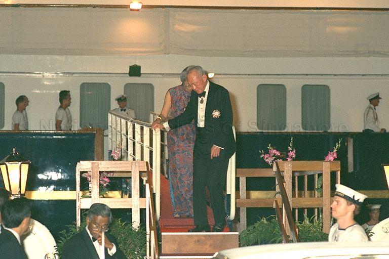 Prime Minister Lee Kuan Yew and his wife, Kwa Geok Choo (partially hidden) disembarking the royal yacht, HMY Britannia at the conclusion of the return banquet hosted by Her Majesty Queen Elizabeth II