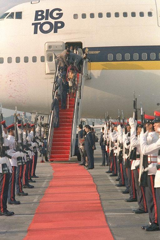 President of Botswana (using forearm crutch) and Mrs Quett K J Masire (yellow blouse) disembarking from the aircraft at Singapore Changi Airport. Waiting to receive them at the foot of the ramp are Minister for Trade and Industry and Second Minister for Defence Brigadier-General Lee Hsien Loong and his wife Madam Ho Ching. Dr Masire is stopping over on his way to the October 18-24 Commonwealth Heads of Government Meeting (CHOGM) in Kuala Lumpur.