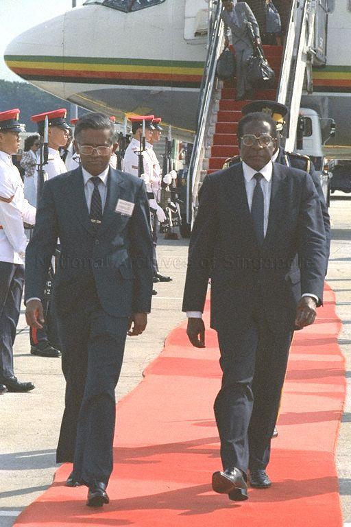 President of Zimbabwe Robert G Mugabe (right) receiving a red-carpet welcome at Singapore Changi Airport. He is accompanied by Director of Protocol and Consular Division, Ministry of Foreign Affairs, V K Rajan (left). Mr Mugabe is stopping over here for a brief visit on his way home from the October 18-24 Commonwealth Heads of Government Meeting (CHOGM) in Kuala Lumpur.