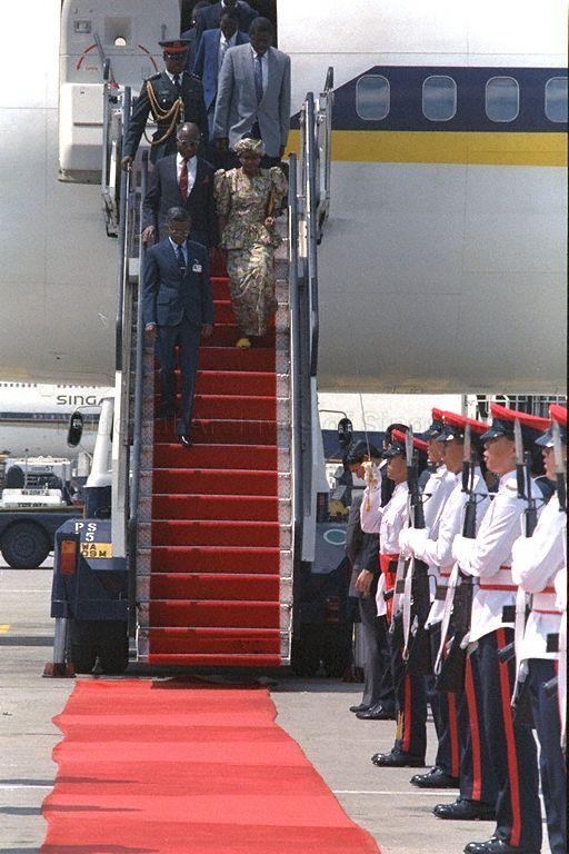 Gambia's President Alhaji Sir Dawda Kairaba Jawara and Lady Chilel Jawara, disembarking from the aircraft at Singapore Changi Airport, led by Director of Protocol and Consular Division, Ministry of Foreign Affairs, V K Rajan. Waiting to receive them at the foot of the ramp (hidden) are Minister for Trade and Industry and Second Minister for Defence Brigadier-General Lee Hsien Loong and his wife, Madam Ho Ching. Sir Dawda is stopping over here for a brief visit on his way home from the October 18-24 Commonwealth Heads of Government Meeting (CHOGM) in Kuala Lumpur.