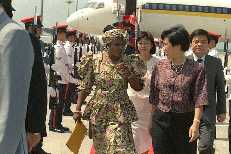 Lady Chilel Jawara (left), wife of President of Gambia, with Madam Ho Ching (right), wife of Minister for Trade and Industry and Second Minister for Defence, at Singapore Changi Airport. The First Lady is visiting Singapore with President Alhaji Sir Dawda Kairaba Jawara, who is stopping over here for a brief visit on his way home from the October 18-24 Commonwealth Heads of Government Meeting (CHOGM) in Kuala Lumpur.