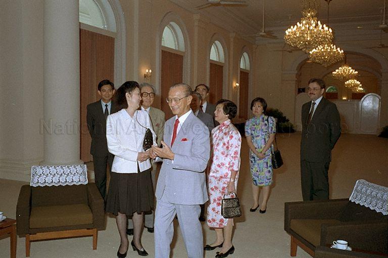 President Wee Kim Wee leading Japanese fashion designer Hanae Mori and her delegation following the official arrival ceremony in the Istana. &nbsp;In the background is General Manager of the Raffles Hotel, Jennie Chua and Executive Director, Richard Helfer.