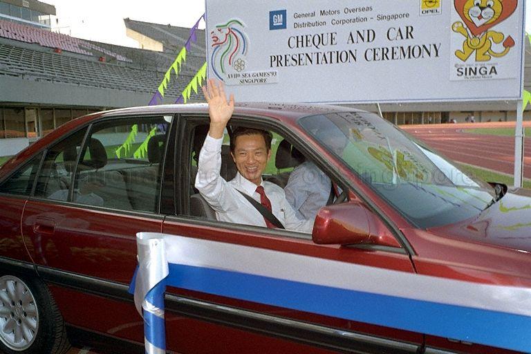 Defence Minister and President of the Singapore National Olympic Council, Dr Yeo Ning Hong waving from the Opel 2.0i donated by General Motors (GM) through its Singapore subsidiary, GM Overseas Distribution Corporation during the cheque and car presentation ceremony at the National Stadium.  GM became a sponsor with a donation of $750,000 in cash and kind to the Games committee of the 17th Southeast Asian Games 1993.  Beside him is Managing Director of GM Overseas Distribution Corporation, Louis J Sorchevich.