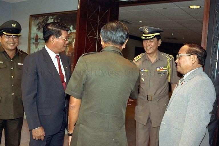 Chief of Defence Force, Major-General Ng Jui Ping (back to camera) receiving a member of the delegation accompanying Philippines Defence Secretary, Renato Salud De Villa (left) during a courtesy call on Minister for Defence, Dr Yeo Ning Hong at the Ministry of Defence