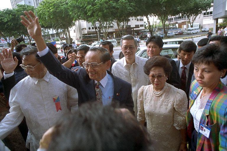 Philippines President Fidel V Ramos, accompanied by First Lady, Amelita Ramos waving to the crowd prior to a meeting with the Filipino community during his three-day state visit to Singapore. Behind them is Philippines ambassador to Singapore, Francisco L Benedicto.
