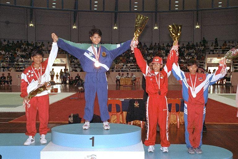17th South-East Asia (SEA) Games 1993 prize presentation ceremony for Women's Silat in the 45-50 kilogram category held at Yio Chu Kang Sports Hall. From left are Singapore's Badriah Mohd Hosni (silver), Brunei's Umi Kalthum Abdul Karin (gold), Indonesia's Nuni Harniati (bronze); and the Philippines' Celia Damonsong (bronze).