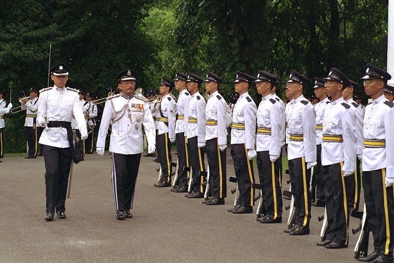 Malaysia's Inspector General of Police (IGP) Tun Mohammed Hanif Bin Omar inspecting the Guard of Honour before the investiture ceremony to receive the Distinguished Service Order award from President Wee Kim Wee in the Istana