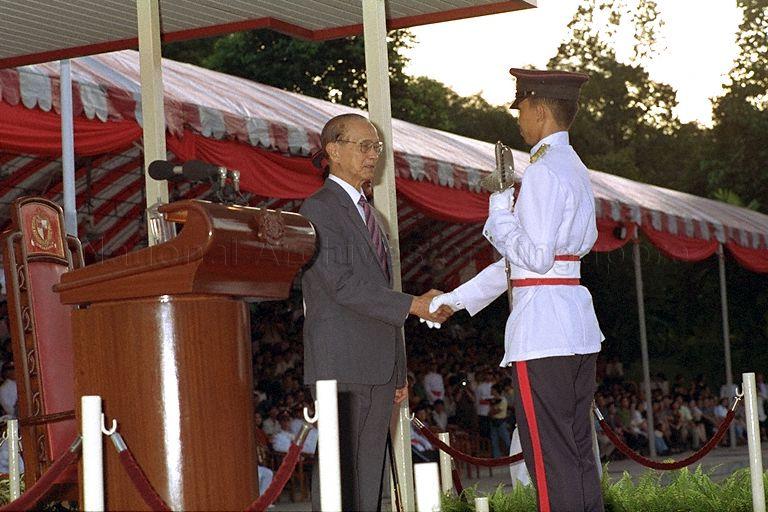 A Sword-of-Honour winner receiving a ceremonial sword from President Wee Kim Wee at the fourth Tri-Service Commissioning Parade for Singapore Armed Forces (SAF) Officer Cadets held at the SAF Training Institute