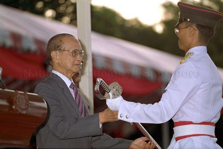 A Sword-of-Honour winner receiving a ceremonial sword from President Wee Kim Wee at the fourth Tri-Service Commissioning Parade for Singapore Armed Forces (SAF) Officer Cadets held at the SAF Training Institute