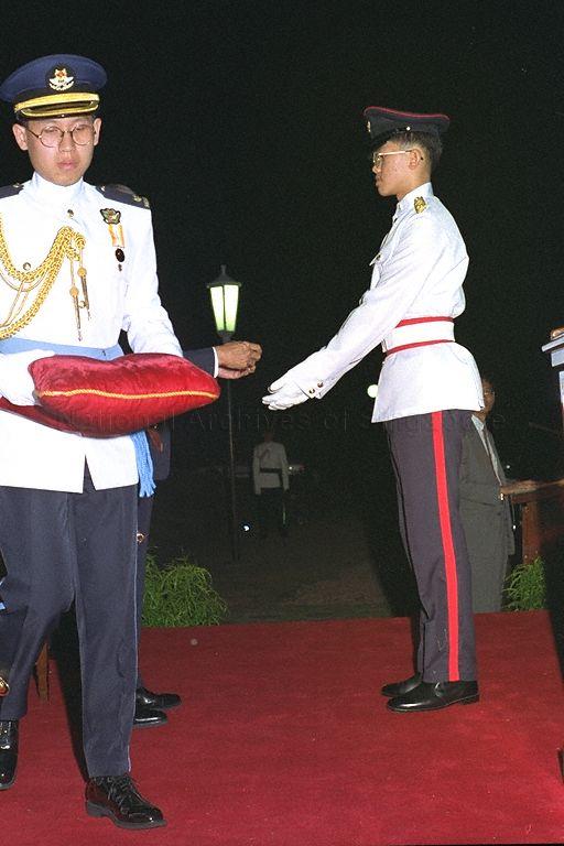 President's Scholar Lionel Cheng Tim-Ee of National Junior College receiving the scholarship award from President Wee Kim Wee (hidden) at presentation ceremony held at Istana
