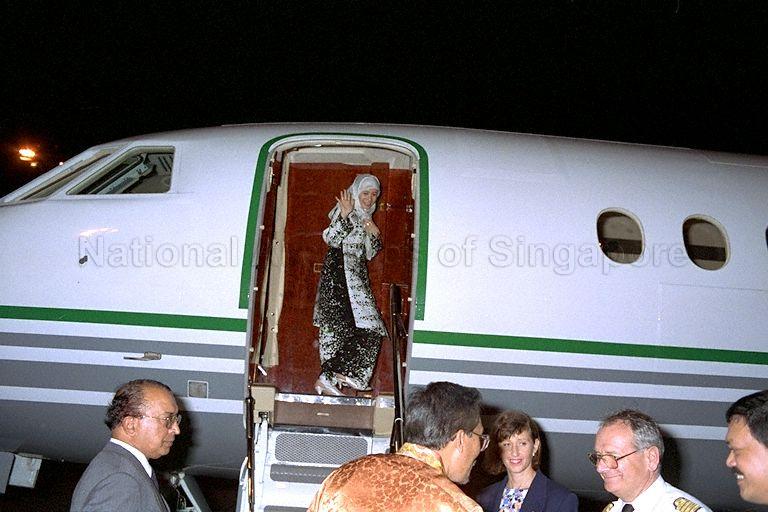 Dr Wan Azizah, wife of Malaysia's Deputy Prime Minister Datuk Seri Anwar Ibrahim (on the tarmac, back to camera) waving from the top of the stairs as she boards the plane for departure at Terminal 1, Singapore Changi Airport